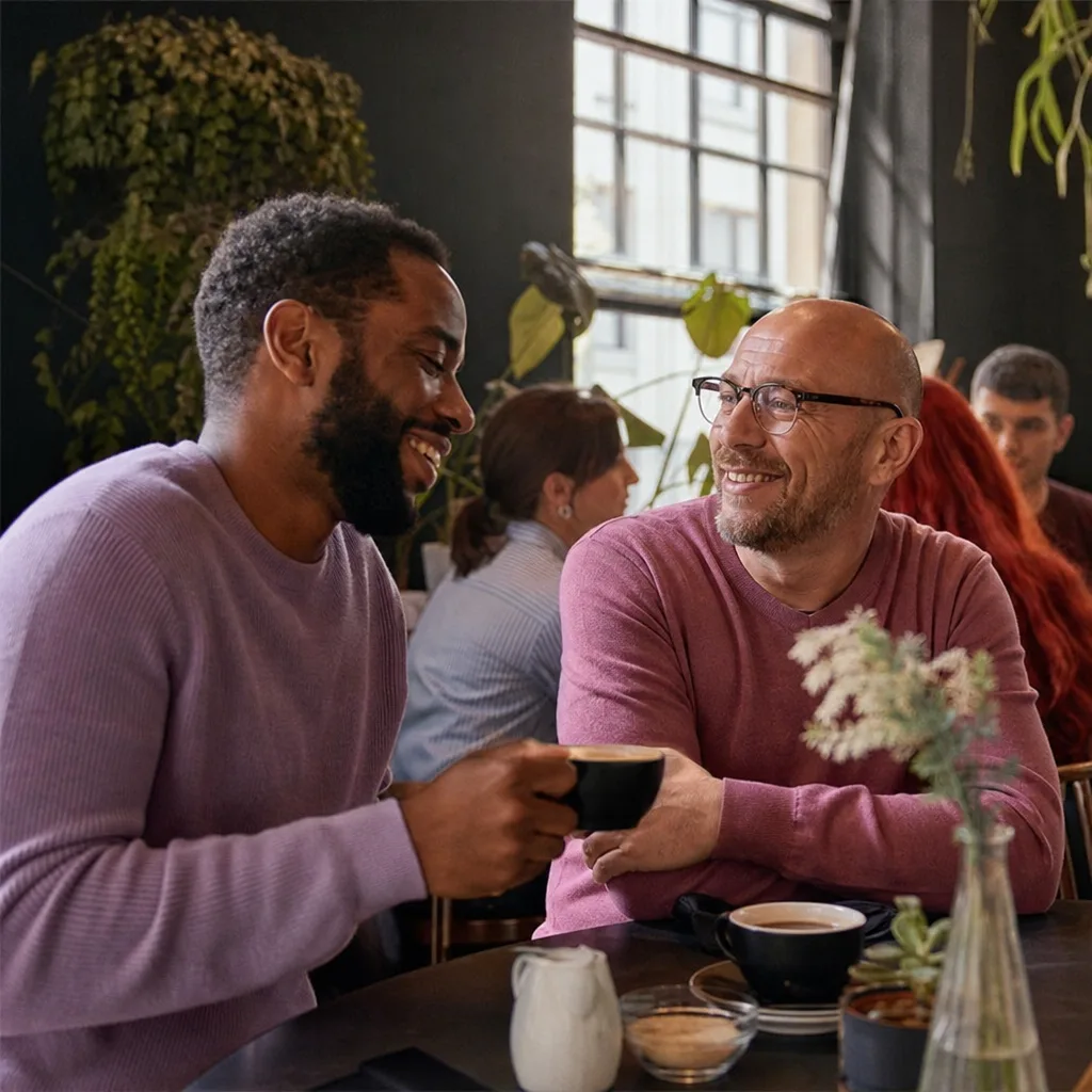 Friends talking at a café near Birmingham's Gay Village